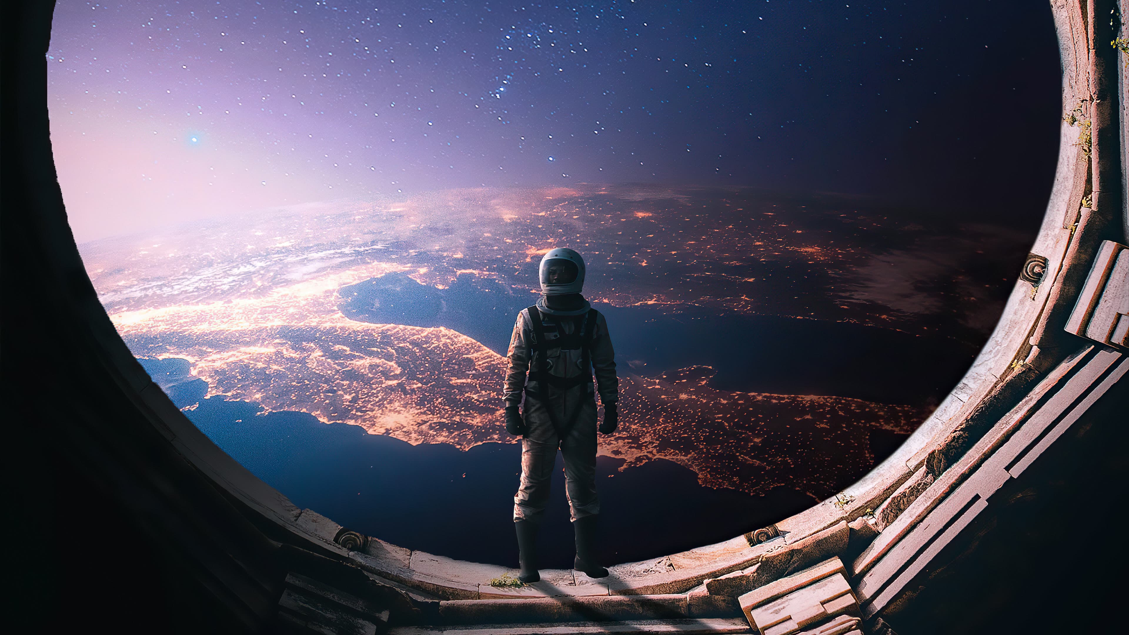 The astronaut at the open hatch once more, Earth's city lights below